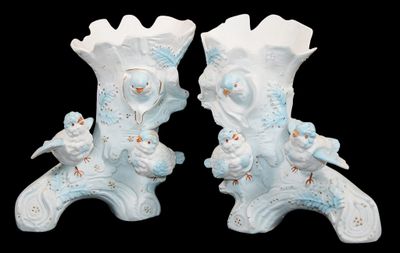 two white vases with birds on them on a black background