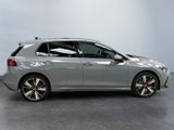 a grey volkswagen golf r - line is parked in a garage