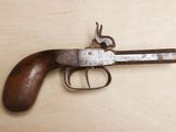 a gun that is on a table with a wooden handle