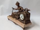 a statue of a woman sitting on top of a clock