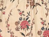 a close up of a dress with flowers and birds on it