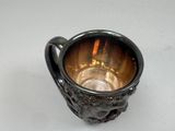 a silver cup that is sitting on a table