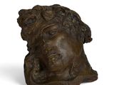 an image of a bronze sculpture of a woman ' s head on a white background