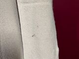 someone is holding a pair of white socks with a hole in it