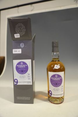 a bottle of whisky sitting next to a box of wine