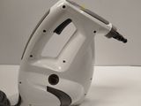 a white and black hand held steam iron on a white table