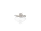 une bague sertie d'un seul diamant, signée Cartier