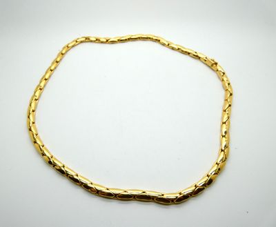 a gold bracelet with a twisted link on a white background