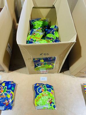 many bags of candy sitting on the floor next to each other