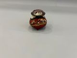 an image of a small red and gold figurine