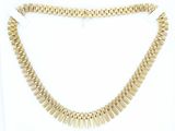 a close up of a gold necklace on a white background