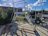 a ladder that is sitting in the middle of a parking lot