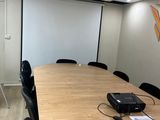 an image of a conference room with a projector and a projector screen