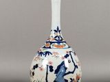 a white vase with a blue and white design on it