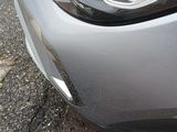 a close up of a car ' s headlight on the street