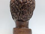 bronze head of a sheep on a wooden base