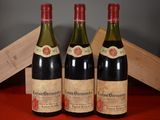 three bottles of wine are sitting on a table next to a wooden box