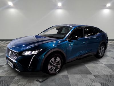 the blue suv is parked on a checkered floor in a garage