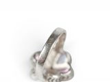 silver plated ring with pink crystal stones on a white background