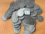 un tas de pièces d'argent posées sur une table en bois