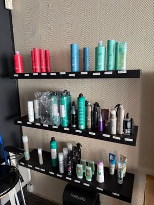 many different types of hair products displayed on the shelves