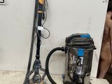 two vacuums and a canister sitting on a table