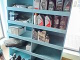 many bottles of motor oil on the shelves in the room