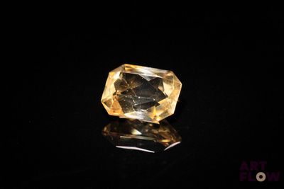 a yellow diamond on a black surface