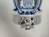 a blue and white vase with a picture of a woman on it