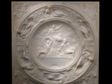 an image of a white relief of a man and a woman in a boat