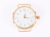 a gold watch with a white face on a white surface