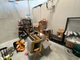 an image of a living room with boxes and a chair