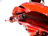 a red purse that is open on a white surface