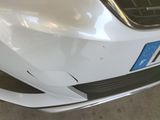 a close up of a car ' s front bumper with a number plate