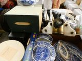 a box full of blue and white china plates and bowls