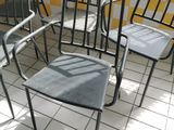 four chairs in a room with yellow and white checkered walls