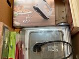 a box that has a microwave in it and some other items in it