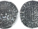 a close up of two silver coins on a white surface