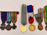 several medals and medals are displayed on a white surface