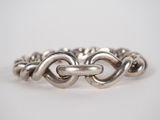 a close up of a silver ring on a white background