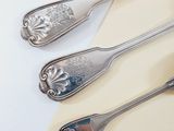 four spoons and two spoon spoons on a table
