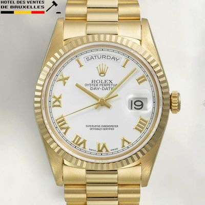 a gold rolex watch with roman numerals and a white dial