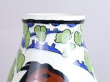 a white vase with a black and red design on it
