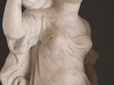 a statue of a woman holding a bird in her hand