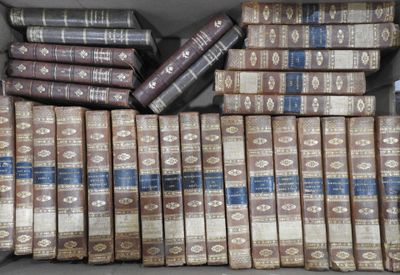 a lot of books that are stacked on top of each other