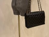chanel black quilted lambskin mini flap bag on mannequin stand