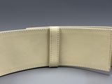 the back of a white leather wallet on a gray surface