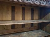 a wooden shelf that has a clock on top of it
