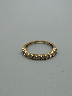 gros plan d'une bague en or sur une surface blanche