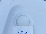 a white toilet with a blue sticker on it